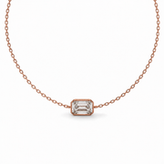 Close-up of an emerald-cut natural diamond bezel bracelet in rose gold.